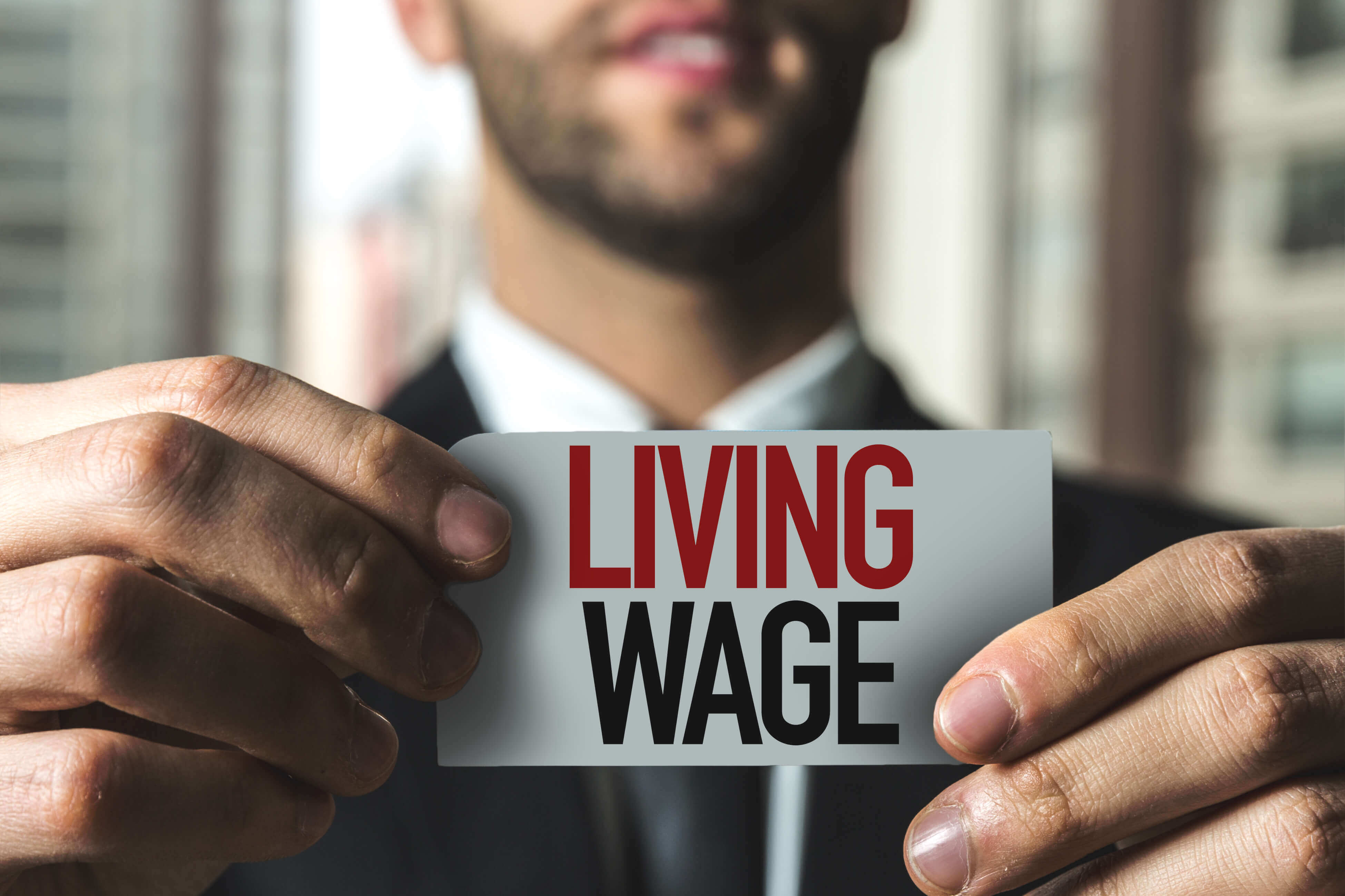 Person holding living wage image