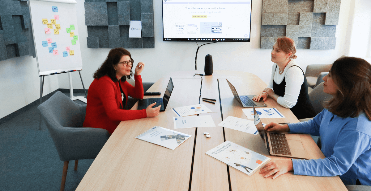 employees sat around table enjoying good employee health and wellbeing support
